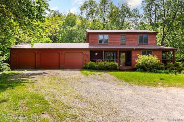 3168 Farmbrook Ln, Metamora, MI 48455 - rustic home with a porch, driveway, and an attached garage