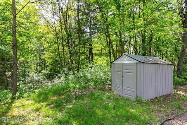 3168 Farmbrook Ln, Metamora, MI 48455 - view of shed with a forest view