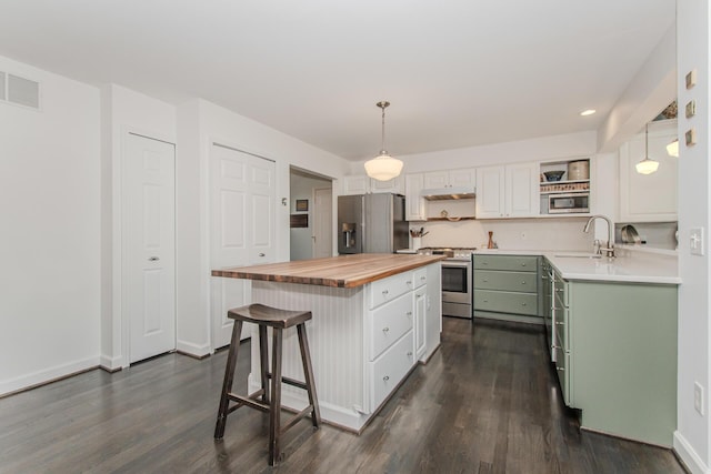 2142 Spring Ridge Dr, Ann Arbor, MI 48103 - kitchen with wooden counters, appliances with stainless steel finishes, a sink, dark wood-type flooring, and white cabinets