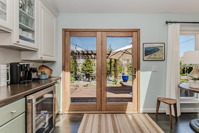 2142 Spring Ridge Dr, Ann Arbor, MI 48103 - doorway to outside with beverage cooler, dark wood-type flooring, and baseboards