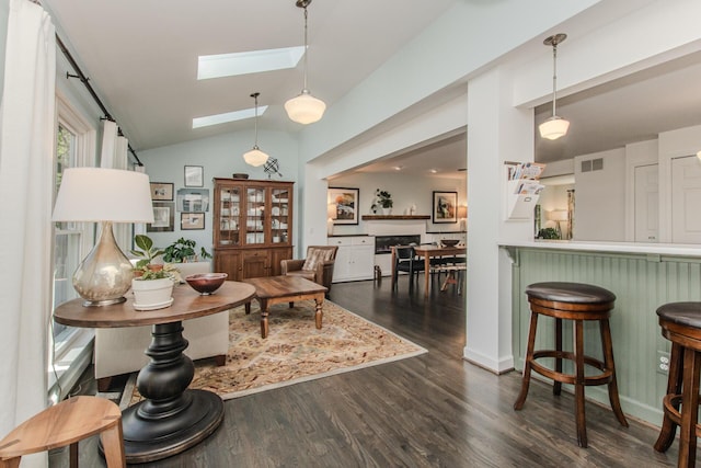 2142 Spring Ridge Dr, Ann Arbor, MI 48103 - living area with dark wood-type flooring, lofted ceiling, and a skylight