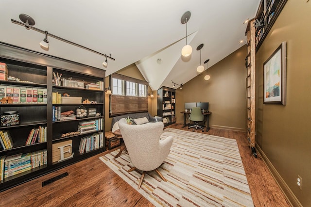 2142 Spring Ridge Dr, Ann Arbor, MI 48103 - sitting room with wood finished floors, baseboards, vaulted ceiling, and a desk