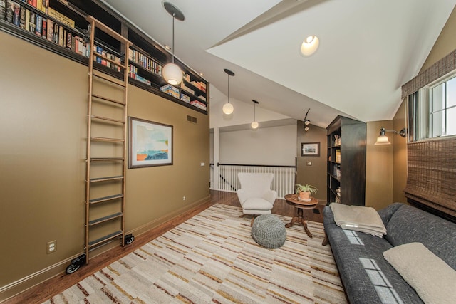 2142 Spring Ridge Dr, Ann Arbor, MI 48103 - sitting room with lofted ceiling, wood finished floors, and baseboards