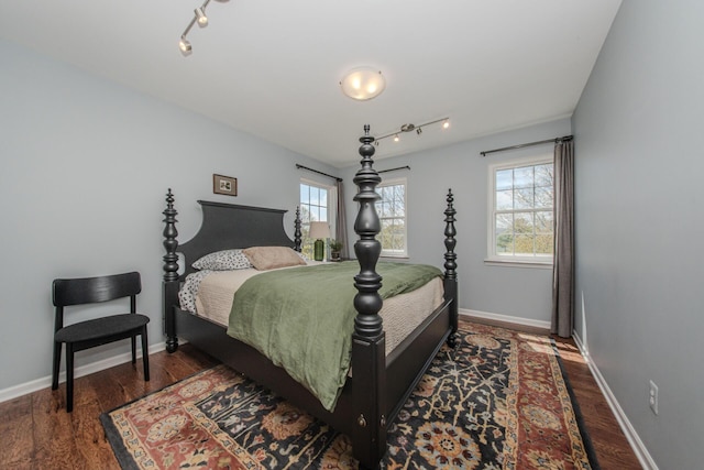 2142 Spring Ridge Dr, Ann Arbor, MI 48103 - bedroom with multiple windows, wood finished floors, and baseboards