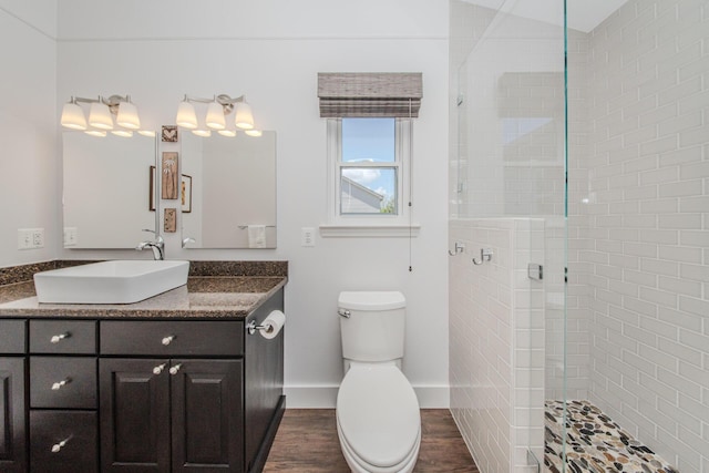 2142 Spring Ridge Dr, Ann Arbor, MI 48103 - bathroom featuring wood finished floors, a walk in shower, toilet, and vanity