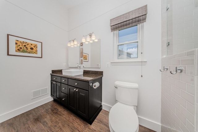 2142 Spring Ridge Dr, Ann Arbor, MI 48103 - bathroom featuring baseboards, wood finished floors, toilet, and vanity