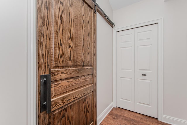 2142 Spring Ridge Dr, Ann Arbor, MI 48103 - detailed view of a barn door, wood finished floors, and baseboards