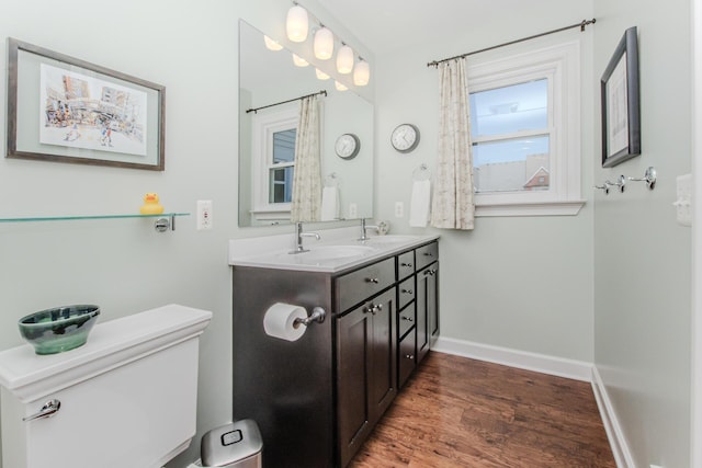 2142 Spring Ridge Dr, Ann Arbor, MI 48103 - bathroom featuring wood finished floors, baseboards, toilet, and double vanity
