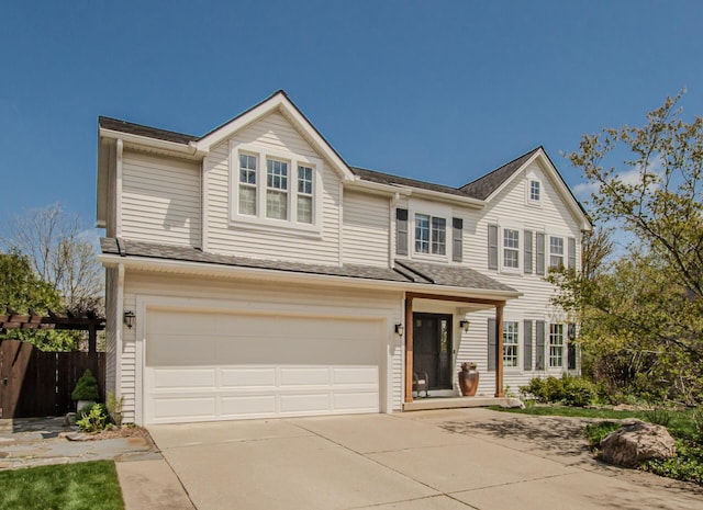 2142 Spring Ridge Dr, Ann Arbor, MI 48103 - traditional home featuring a garage, driveway, and fence