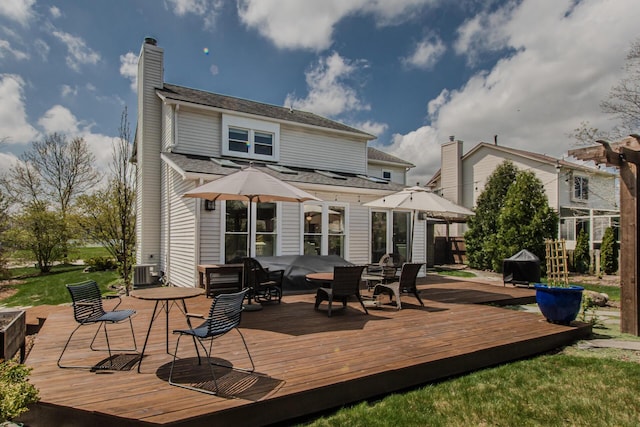 2142 Spring Ridge Dr, Ann Arbor, MI 48103 - rear view of house with central AC, a chimney, and a wooden deck