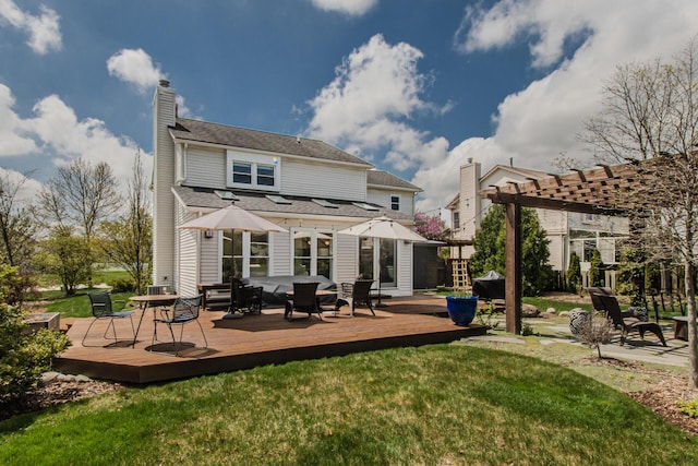 2142 Spring Ridge Dr, Ann Arbor, MI 48103 - back of property with a chimney, a lawn, and a deck