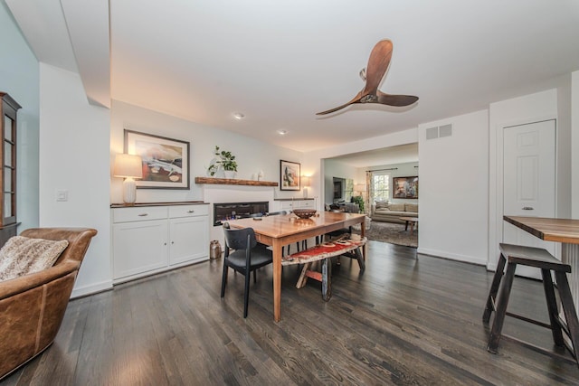 2142 Spring Ridge Dr, Ann Arbor, MI 48103 - dining room featuring dark wood-style flooring, ceiling fan, and baseboards