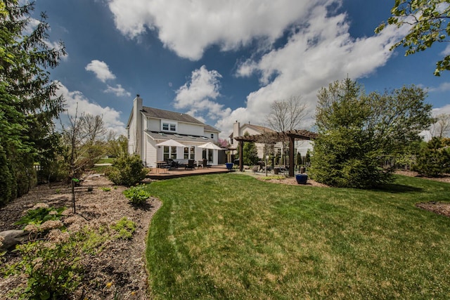2142 Spring Ridge Dr, Ann Arbor, MI 48103 - back of house with a pergola, a wooden deck, a chimney, and a lawn