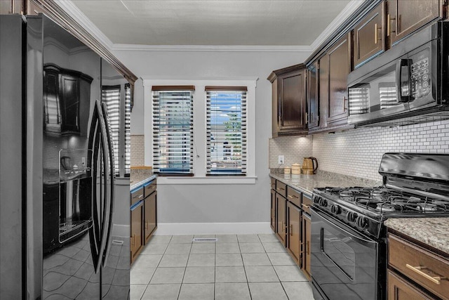 kitchen with black appliances, light tile patterned floors, tasteful backsplash, light stone countertops, and dark brown cabinets