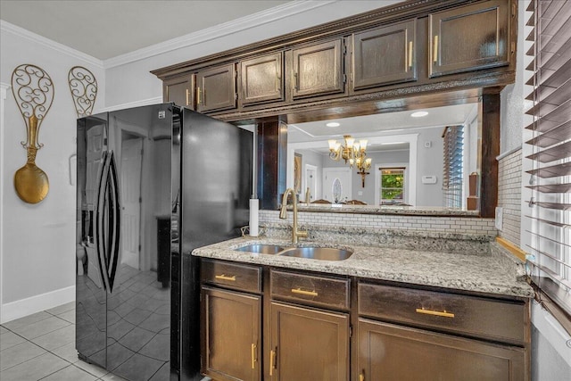 bathroom featuring a chandelier, ornamental molding, tile patterned flooring, decorative backsplash, and baseboards
