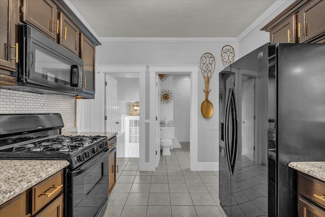 kitchen featuring black appliances, decorative backsplash, crown molding, light tile patterned flooring, and light stone countertops