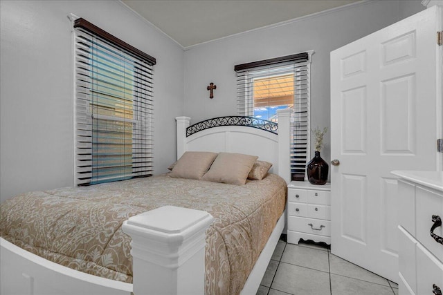bedroom featuring crown molding and light tile patterned flooring