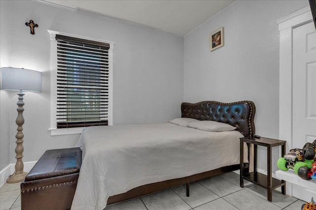 bedroom featuring tile patterned floors and ornamental molding