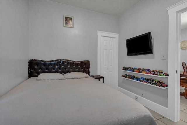tiled bedroom featuring ornamental molding
