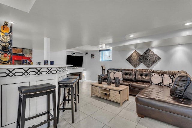 living room with light tile patterned floors, baseboards, and recessed lighting