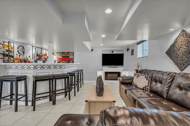 living area featuring light tile patterned flooring, a fireplace, and recessed lighting