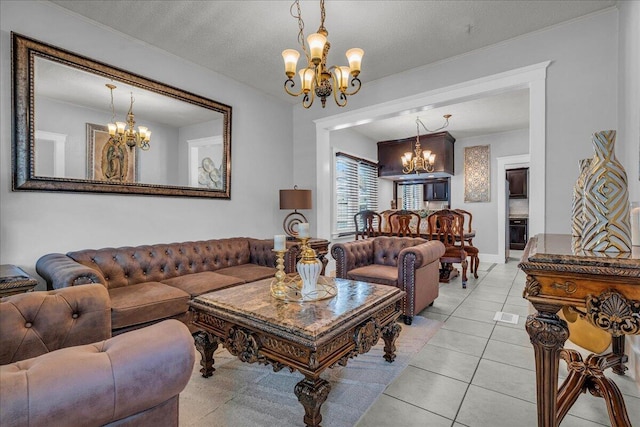 living room featuring a chandelier, light tile patterned flooring, and a textured ceiling