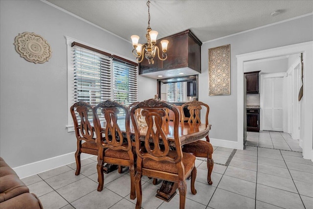 dining space featuring crown molding, a chandelier, light tile patterned flooring, baseboards, and a textured ceiling