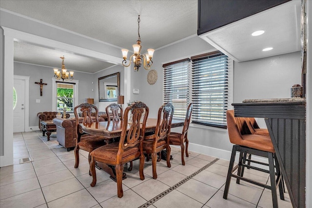 dining space featuring a chandelier, light tile patterned floors, ornamental molding, baseboards, and a textured ceiling