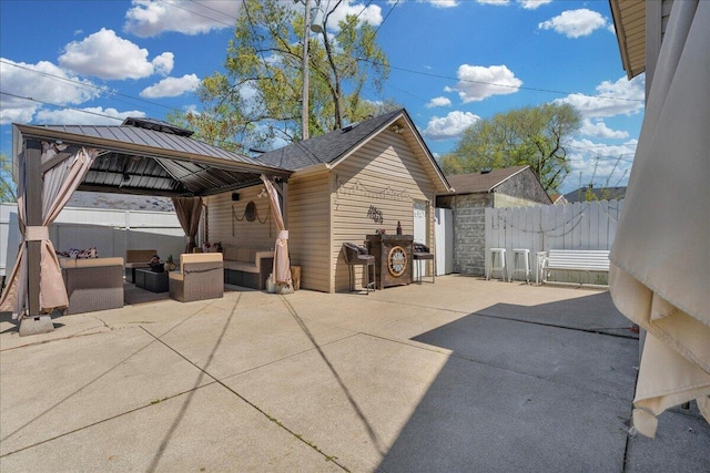 view of patio featuring a gazebo, outdoor lounge area, and fence