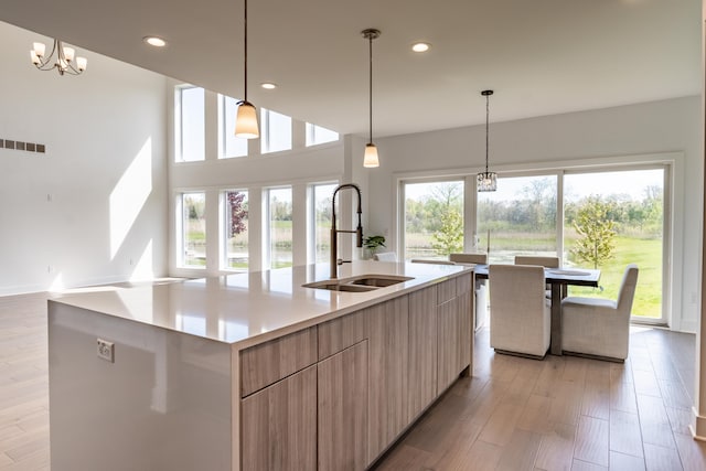 54598 Deadwood Ln, Utica, MI 48316 - kitchen featuring a sink, modern cabinets, a kitchen island with sink, light countertops, and recessed lighting