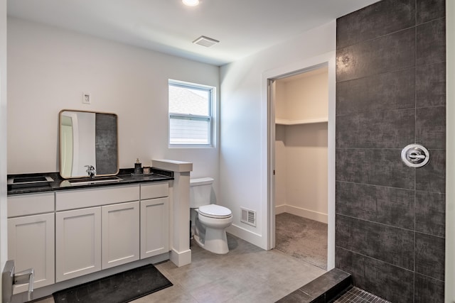 54598 Deadwood Ln, Utica, MI 48316 - bathroom with toilet, tiled shower, vanity, and a walk in closet