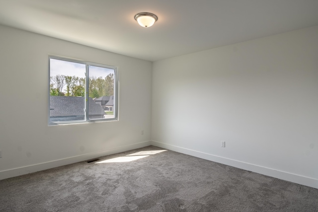 54598 Deadwood Ln, Utica, MI 48316 - spare room featuring dark colored carpet and baseboards