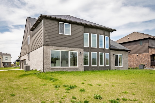 54598 Deadwood Ln, Utica, MI 48316 - rear view of property featuring brick siding, cooling unit, and a lawn