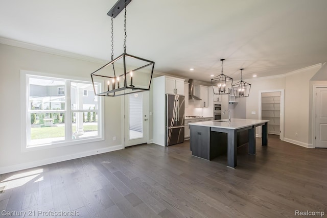 9058 Fielding Dr, Brighton, MI 48116 - kitchen with stainless steel fridge, wall chimney range hood, a chandelier, ornamental molding, and an island with sink