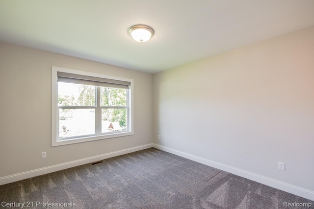 9058 Fielding Dr, Brighton, MI 48116 - unfurnished room featuring baseboards and dark carpet