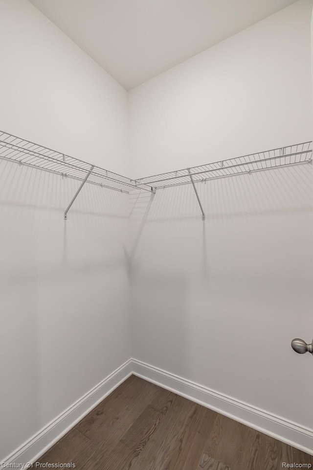 9058 Fielding Dr, Brighton, MI 48116 - walk in closet featuring dark wood finished floors