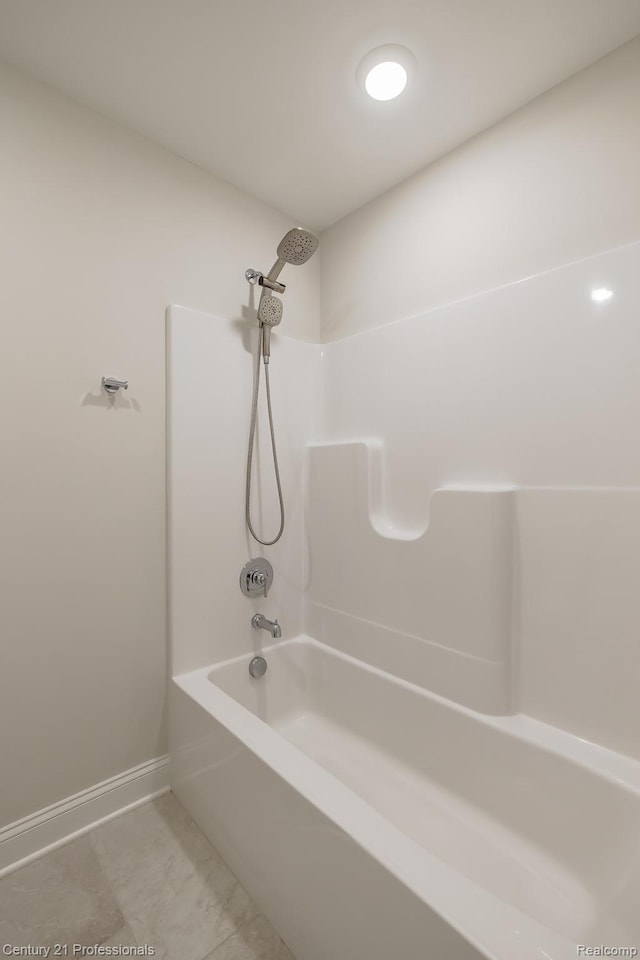 9058 Fielding Dr, Brighton, MI 48116 - full bathroom featuring baseboards and washtub / shower combination
