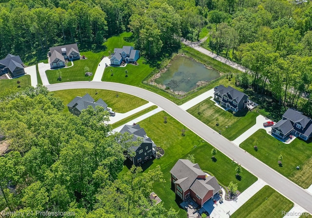 9058 Fielding Dr, Brighton, MI 48116 - aerial view of property's location featuring a nearby body of water, nearby suburban area, and a heavily wooded area