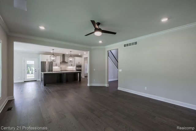 9058 Fielding Dr, Brighton, MI 48116 - unfurnished living room featuring a ceiling fan, baseboards, dark wood-type flooring, ornamental molding, and recessed lighting