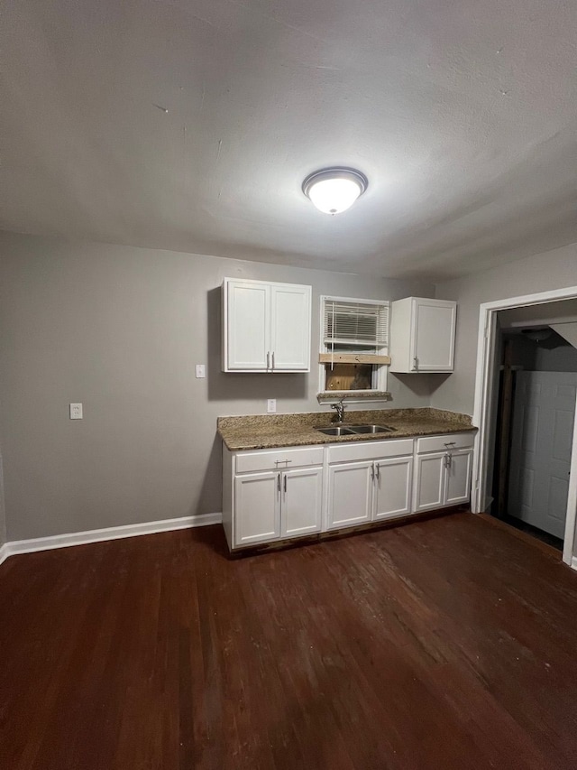14903 Woodmont Ave, Detroit, MI 48227 - kitchen with a sink, baseboards, dark wood-style flooring, and white cabinetry