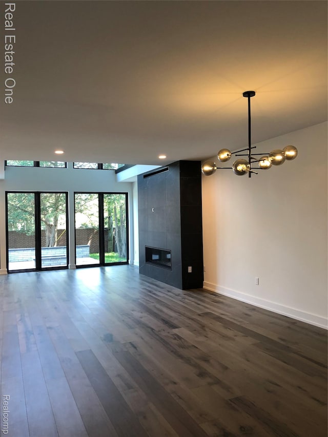 145 Westchester Way, Birmingham, MI 48009 - unfurnished living room featuring a chandelier, dark wood-style floors, baseboards, a fireplace, and recessed lighting