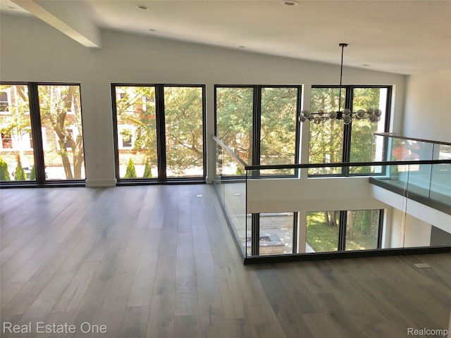 145 Westchester Way, Birmingham, MI 48009 - empty room with lofted ceiling, a chandelier, and wood finished floors
