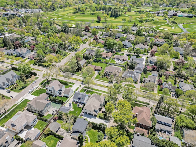aerial view of property and surrounding area with nearby suburban area and a golf course