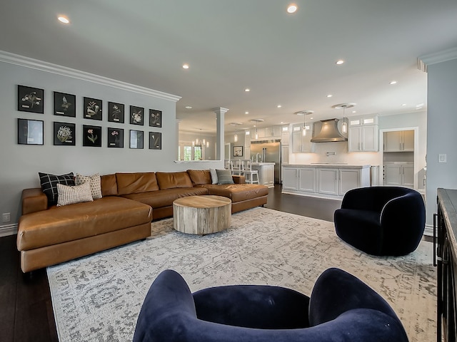 living room with crown molding, recessed lighting, dark wood-style floors, and ornate columns