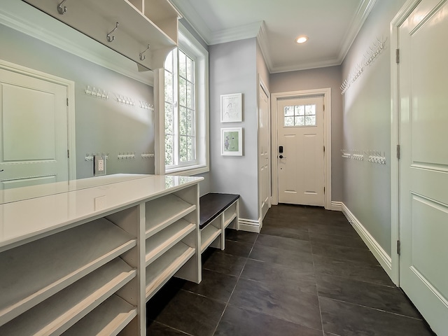 mudroom with ornamental molding, dark tile patterned flooring, baseboards, and recessed lighting