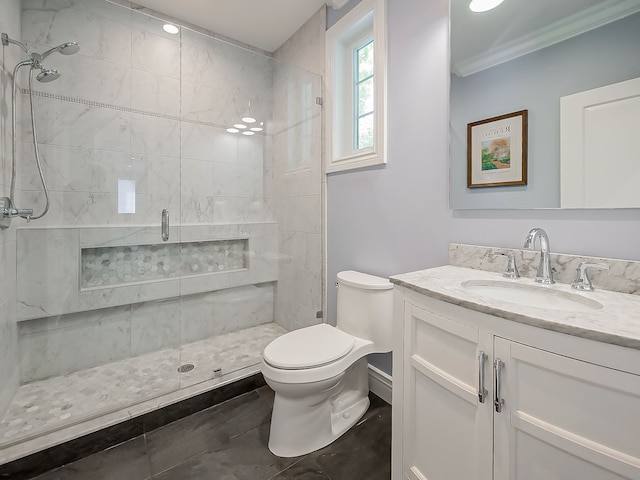 bathroom featuring a shower stall, toilet, vanity, and ornamental molding