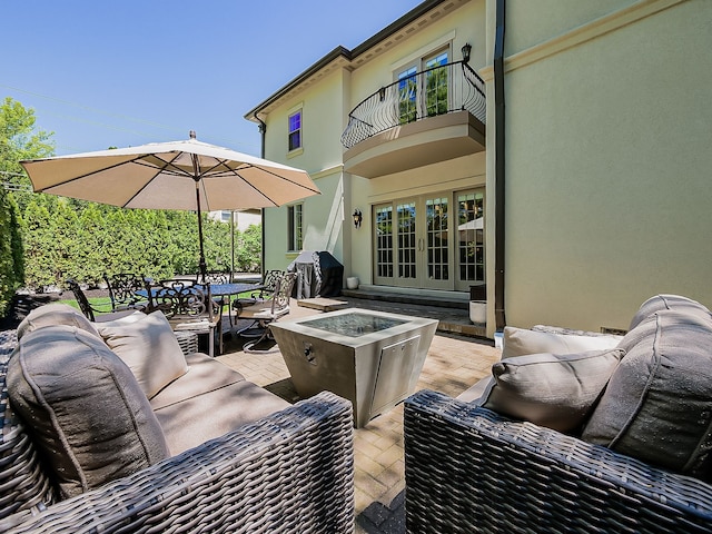 view of patio with a balcony, an outdoor hangout area, outdoor dining area, french doors, and grilling area