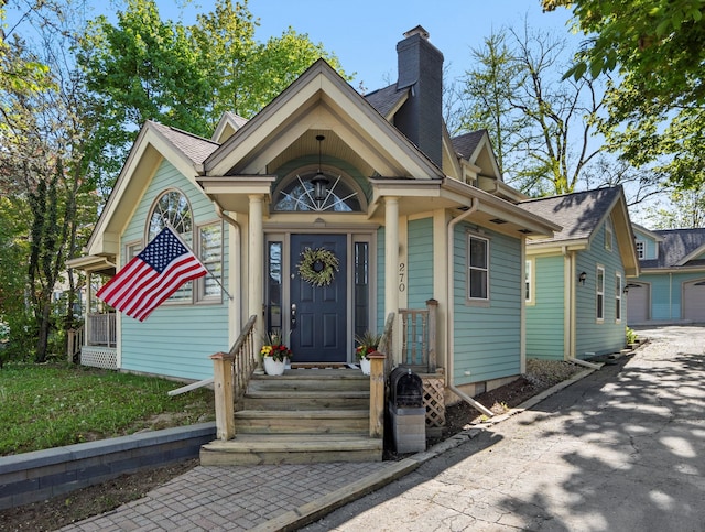 270 S Center St, Northville, MI 48167 - view of front facade with a chimney and a shingled roof