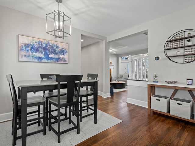 270 S Center St, Northville, MI 48167 - dining area featuring wood finished floors, a chandelier, and baseboards