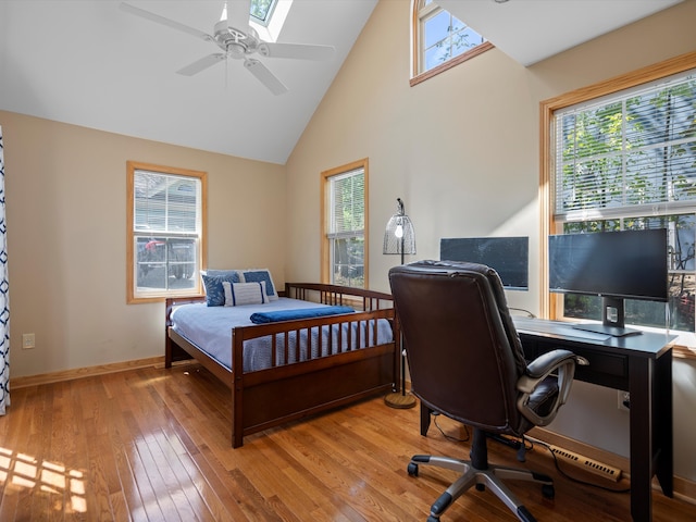 270 S Center St, Northville, MI 48167 - bedroom featuring multiple windows, light wood finished floors, high vaulted ceiling, a desk, and baseboards